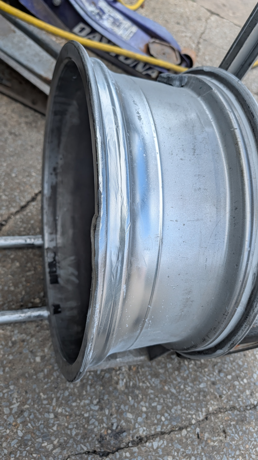Repaired aluminum rim with a finished weld along the lip